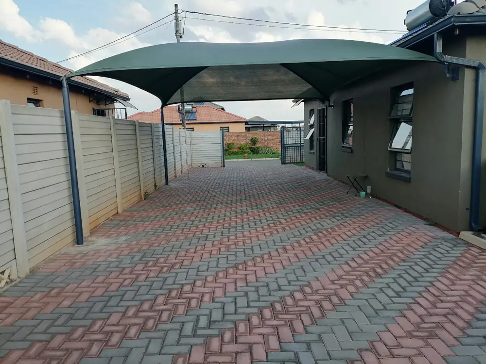 Green shade sail, paved driveway
